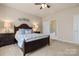 Bedroom with a bed, ceiling fan, carpet, bathroom, and two windows at 44409 Oriole Dr # 200, Indian Land, SC 29707