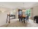 Cozy dining area with a classic wood table, china cabinet, and staircase leading to the living area at 44409 Oriole Dr # 200, Indian Land, SC 29707