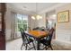 Dining area with a chandelier, window view and dark wood table with black chairs at 44409 Oriole Dr # 200, Indian Land, SC 29707