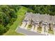 Aerial view of townhomes featuring attached garages, manicured landscaping, and lush green surroundings at 44409 Oriole Dr # 200, Indian Land, SC 29707