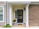 Inviting front entrance with a black door, sidelights, and decorative wreath, framed by white columns at 44409 Oriole Dr # 200, Indian Land, SC 29707