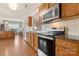 Well-equipped kitchen with stainless steel appliances, wood cabinetry, and hardwood floors at 44409 Oriole Dr # 200, Indian Land, SC 29707