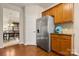 Kitchen featuring stainless steel appliances, wood cabinets, hardwood floor and a door leading to dining area at 44409 Oriole Dr # 200, Indian Land, SC 29707