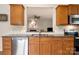 Well-lit kitchen featuring stainless steel appliances, wooden cabinetry, and granite countertops at 44409 Oriole Dr # 200, Indian Land, SC 29707