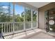 Relaxing screened-in porch offering views of the green backyard and wooded scenery beyond at 44409 Oriole Dr # 200, Indian Land, SC 29707