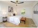 Bright bedroom boasts natural light, a ceiling fan, and neutral decor at 4754 Hedgemore Dr # E, Charlotte, NC 28209