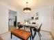 Modern dining room adjacent to an updated kitchen with stainless appliances and white cabinets at 4754 Hedgemore Dr # E, Charlotte, NC 28209