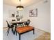 Modern dining room with stylish lighting, table, chairs, and bench seating at 4754 Hedgemore Dr # E, Charlotte, NC 28209