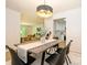 Dining room with modern table and chairs, and an open view into the cozy living room at 4754 Hedgemore Dr # E, Charlotte, NC 28209
