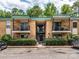 Apartment building featuring brick facade, balconies with iron railings, and well-maintained landscaping at 4754 Hedgemore Dr # E, Charlotte, NC 28209