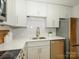 Modern kitchen featuring stainless steel appliances, white cabinets, and a stylish backsplash at 4754 Hedgemore Dr # E, Charlotte, NC 28209