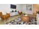 Well-lit living room with modern furniture and a view of the bright, clean, and updated kitchen at 4754 Hedgemore Dr # E, Charlotte, NC 28209