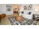 Cozy living room with decorative rug, sofa, and view into the dining area and kitchen at 4754 Hedgemore Dr # E, Charlotte, NC 28209