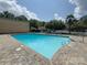 Community pool area with blue water, brick pavers, and lounge chairs at 4754 Hedgemore Dr # E, Charlotte, NC 28209