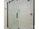Sleek walk-in shower with glass door, white tile, and modern fixtures at 4754 Hedgemore Dr # E, Charlotte, NC 28209
