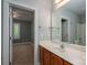 Bathroom view to bedroom featuring a vanity with a sink, mirror, wood cabinets, and tile floors at 506 Academy St, Mcadenville, NC 28101