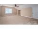 Spacious bedroom features carpet floors, base molding, a closet, a window, a ceiling fan, and light-gray walls at 506 Academy St, Mcadenville, NC 28101