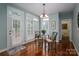 Bright dining area with a glass table set, white shutters, and a view of a nearby powder room at 506 Academy St, Mcadenville, NC 28101