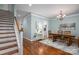 Light-filled dining room with hardwood floors and classic chair rail at 506 Academy St, Mcadenville, NC 28101