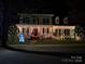 Charming home exterior adorned with festive holiday lights, snowman, and reindeer decorations at 506 Academy St, Mcadenville, NC 28101