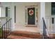 Inviting front entrance with a wreath, sidelights, and brick steps at 506 Academy St, Mcadenville, NC 28101