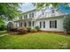 Traditional two-story home featuring a welcoming front porch, mature landscaping, and classic black shutters at 506 Academy St, Mcadenville, NC 28101