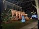 Festive front yard with Christmas lights, decorations, a snowman, and a beautifully decorated home at 506 Academy St, Mcadenville, NC 28101