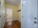 Hallway with hardwood floors and a view into the nearby laundry room at 506 Academy St, Mcadenville, NC 28101