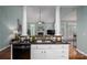 An open-concept kitchen with an island with marble countertops and white cabinets at 506 Academy St, Mcadenville, NC 28101