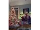 Cozy living room featuring a decorated Christmas tree, a fireplace mantel, and a Santa Claus painting at 506 Academy St, Mcadenville, NC 28101