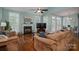 A bright living room with a fireplace, ceiling fan, and natural lighting at 506 Academy St, Mcadenville, NC 28101