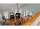 Open-concept living room with hardwood floors, fireplace, ceiling fan, and multiple windows for natural light at 506 Academy St, Mcadenville, NC 28101