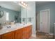 Bright main bathroom with double sinks, wood cabinets, and a glass-door shower at 506 Academy St, Mcadenville, NC 28101
