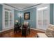 This home office has natural lighting and a traditional design with a dark wood desk at 506 Academy St, Mcadenville, NC 28101