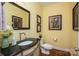 Stylish powder room with decorative accents, a vessel sink, and framed artwork at 506 Academy St, Mcadenville, NC 28101