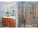 Clean bathroom shower with tiled walls, glass door, and a view of the double vanity at 506 Academy St, Mcadenville, NC 28101