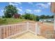 A backyard with a white railed porch with views of additional buildings in the distance at 5090 Beaver Dam Way, Bessemer City, NC 28016
