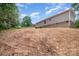 A spacious backyard with some slope features a view of the back of the home at 5090 Beaver Dam Way, Bessemer City, NC 28016