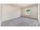 A bright bedroom features a window with natural light and neutral wall colors at 5090 Beaver Dam Way, Bessemer City, NC 28016