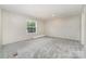 Carpeted bedroom featuring a bright window, creating a comfortable and inviting space to relax at 5090 Beaver Dam Way, Bessemer City, NC 28016