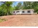 This house offers a charming curb appeal with its gray siding, black shutters, and welcoming front porch at 5090 Beaver Dam Way, Bessemer City, NC 28016