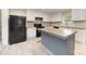 Modern kitchen with stainless steel appliances and a spacious island, ideal for cooking and gathering at 5090 Beaver Dam Way, Bessemer City, NC 28016
