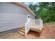 A wooden porch with white railings with a view of the backyard and house siding at 5090 Beaver Dam Way, Bessemer City, NC 28016