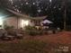 Backyard with patio seating area and lush greenery. Perfect for outdoor entertaining and relaxation at 524 Heritage Vw, Indian Trail, NC 28079