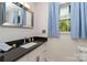 Bright bathroom featuring a granite countertop and window at 524 Heritage Vw, Indian Trail, NC 28079