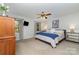 A cozy bedroom with a ceiling fan, a plush queen bed, and natural light from the windows at 524 Heritage Vw, Indian Trail, NC 28079