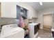 Bright laundry room featuring modern washer/dryer, hanging rack and stylish tile floor at 524 Heritage Vw, Indian Trail, NC 28079