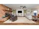 Relaxing living space featuring a brick fireplace, hardwood floors, and natural light at 524 Heritage Vw, Indian Trail, NC 28079