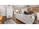 Open-concept living room featuring a brick fireplace, modern furniture, and seamless flow to the kitchen and dining area at 524 Heritage Vw, Indian Trail, NC 28079