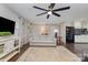 Bright living room with modern decor, featuring hardwood floors and an open layout to the kitchen at 524 Heritage Vw, Indian Trail, NC 28079